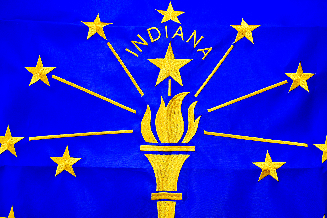 Side-by-side comparison of a sewn flag, a digitally printed flag, and an embroidered flag showing different detailing and texture