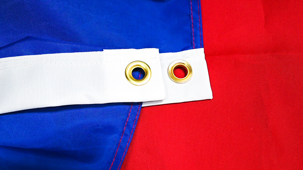 Side-by-side comparison of a 210D polyester flag and a standard economy flag after 6 months of outdoor exposure, highlighting fading, fraying, and fabric integrity differences