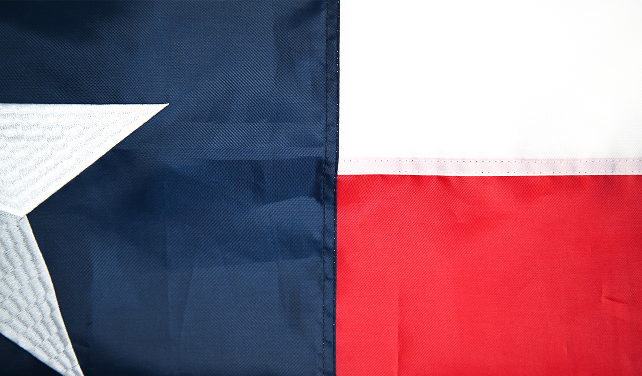 Close-up comparison of a sewn flag showing stitched seams and a printed flag showing smooth dye-sublimation surface, with labels
