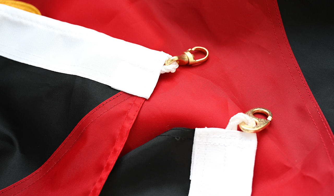 Close-up comparison of 210D polyester fabric texture versus standard flag fabric, showing tighter weave and more vibrant color saturation