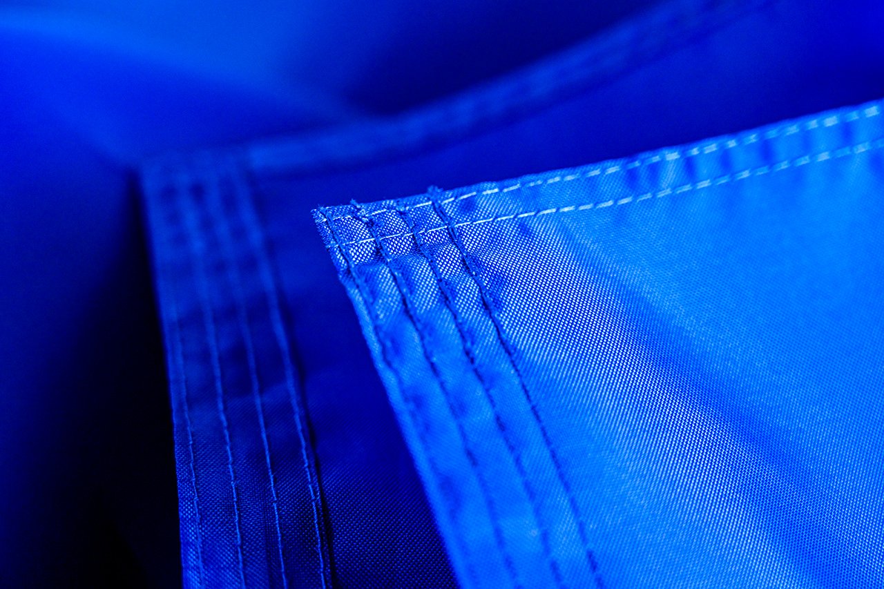 Dye-sublimation printing process on 210D polyester flag fabric showing vibrant color saturation and fine detail
