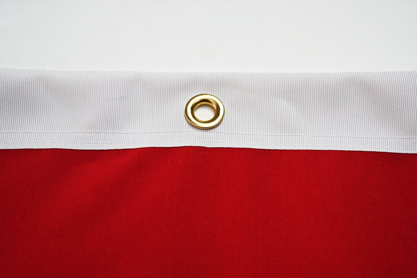 Close-up of a dye-sublimation heat press transferring a colorful flag design onto white polyester fabric