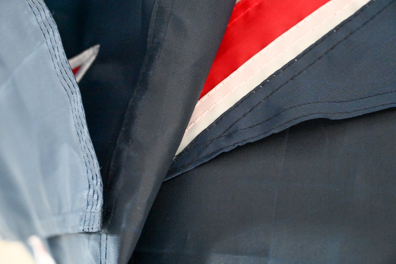 Diagram showing fly-end reinforcement options: multi-row stitching, reinforcement tape, bartack corners and triangular corner patches on a flag